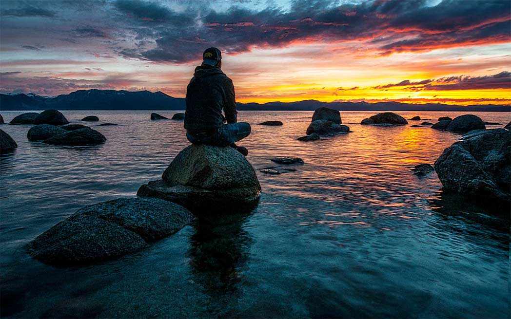 person-sitting-alone-on-rock_westmountmag