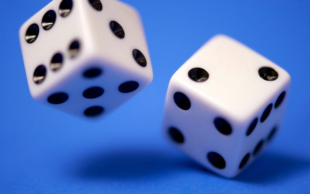 White dices on blue surface - Photo by Edge2Edge Media - Unsplash