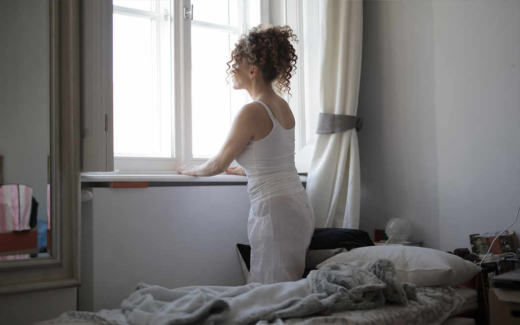 woman-looking-through-window_westmountmag